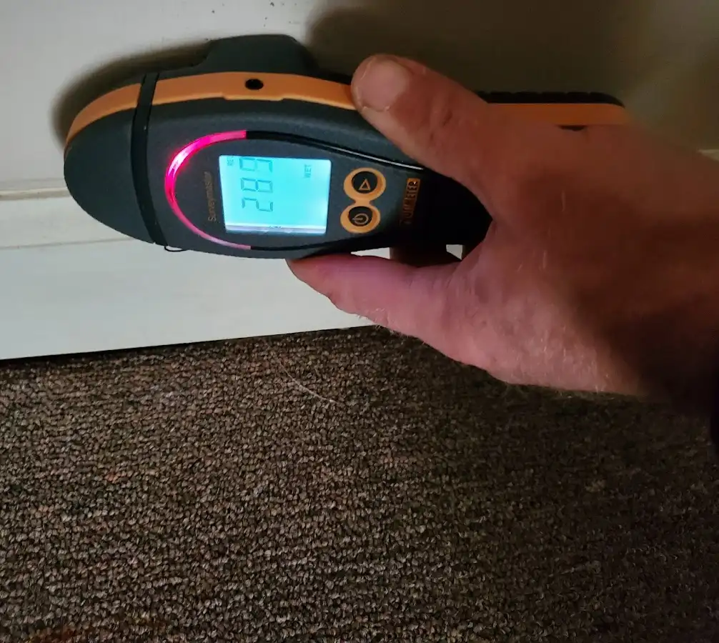 Moisture detection at baseboard during Storm Damage Restoration in Bartow